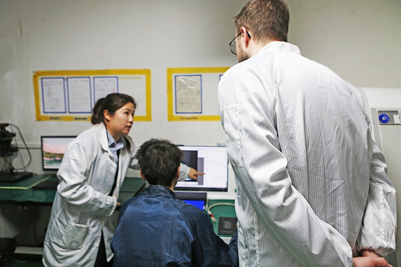 A engineer in dark blue uniform is changing parameters